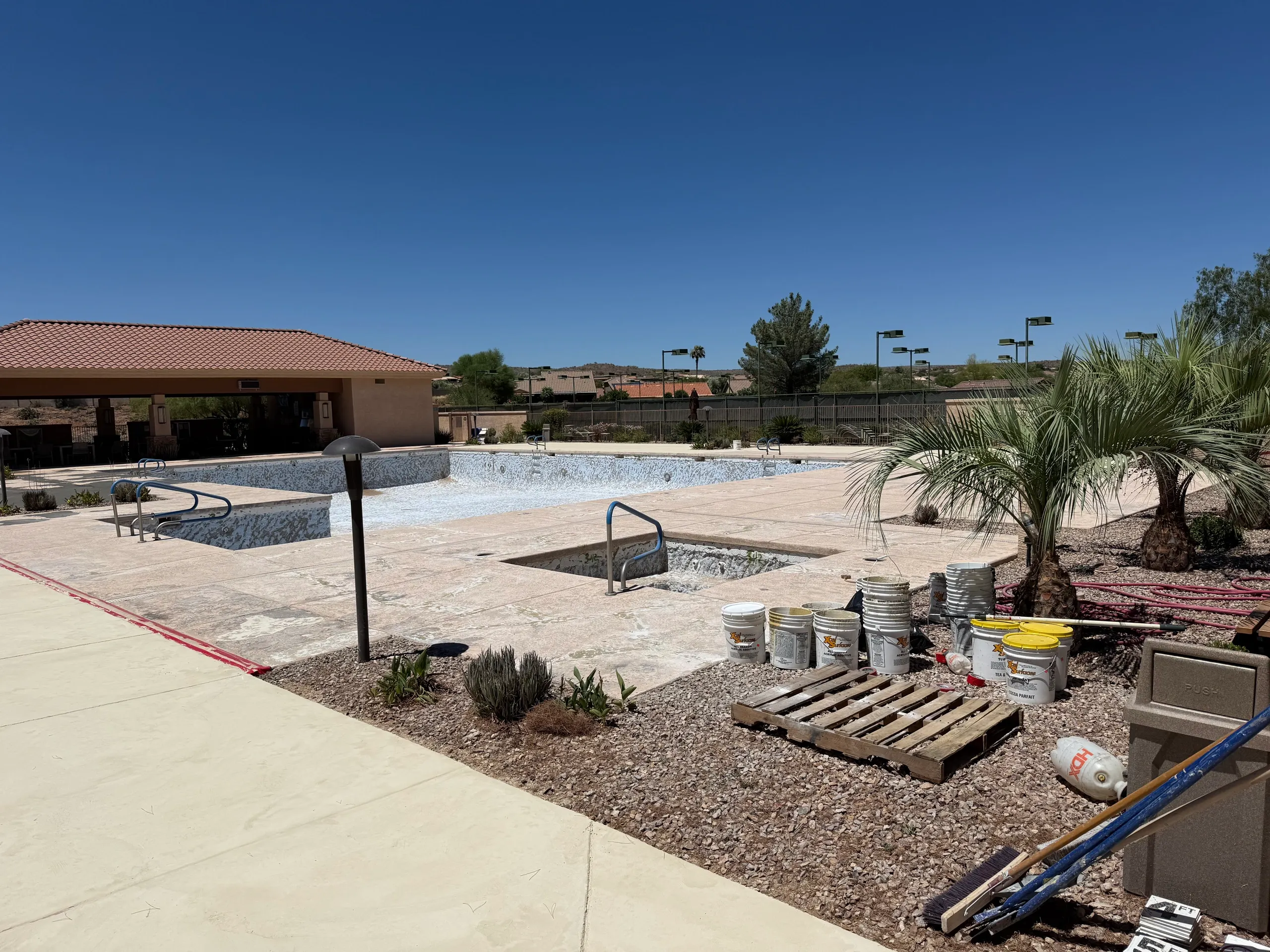 Community pool under construction desert landscape