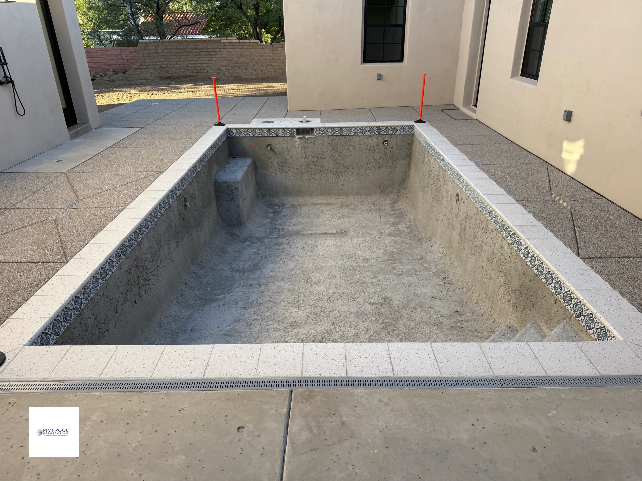 Pool construction waterline tile installation